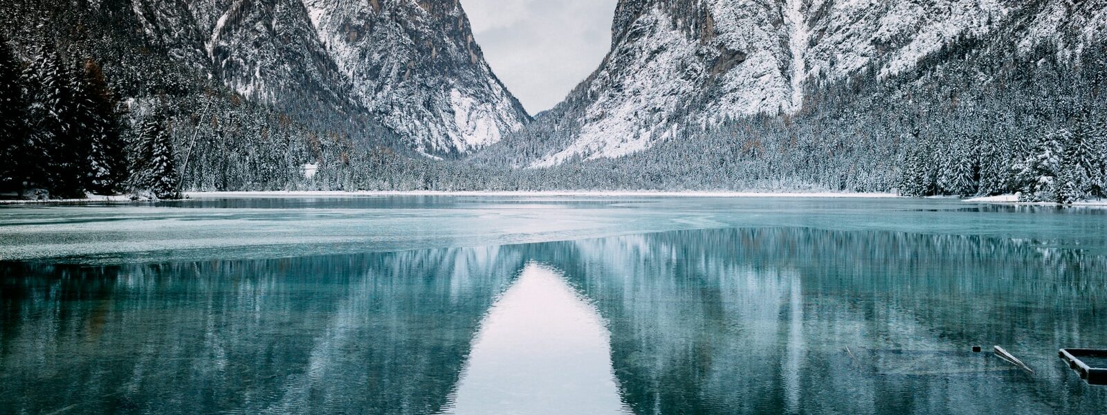 body of water and snow-covered mountains during daytime